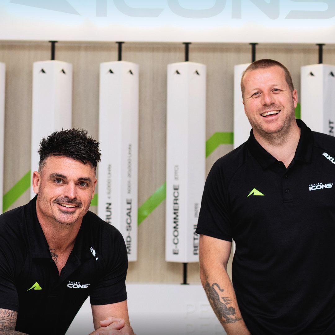 The Health Icons team wearing branded black polos in their workspace.